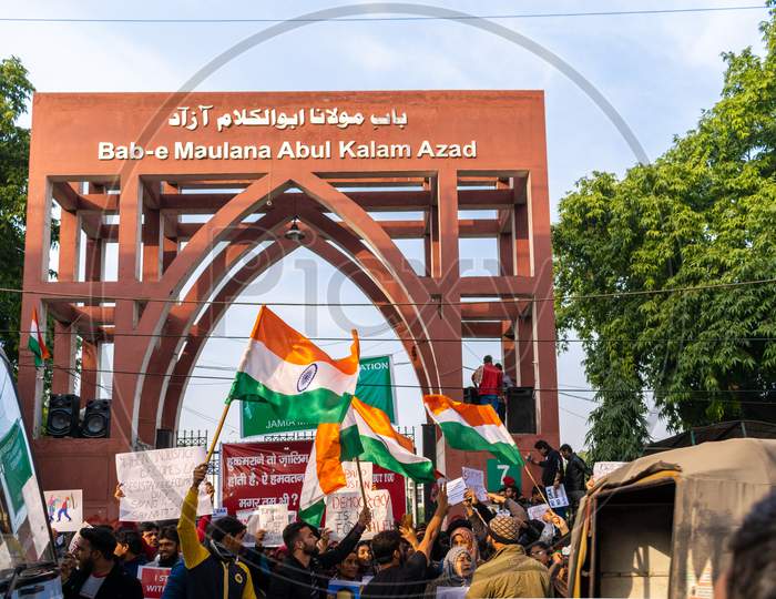 People With Indian Flags banners and posters Protesting Against Caa And Nrc Outside Bab E Maulana Abul Kalam Azad Gate No 7 Jamia Millia Islamia A Central University In New Delhi