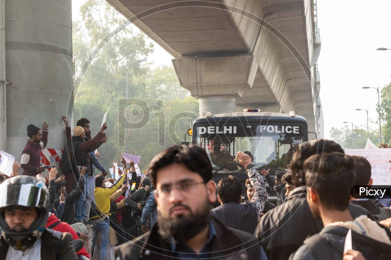 Delhi Police bus passing through the crowd during The Protest Against Caa And Nrc Outside Jamia Millia Islamia University