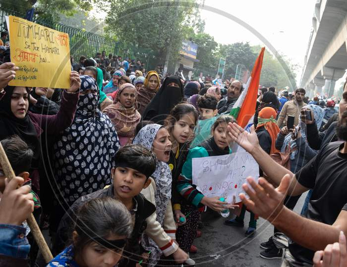 Children and others chanting the slogans against CAA and NRC outside Jamia Millia Islamia University