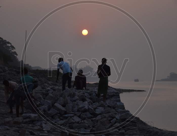 Fisherman Setting Up Rocks on The Bank Of Bramaputra River in Assam
