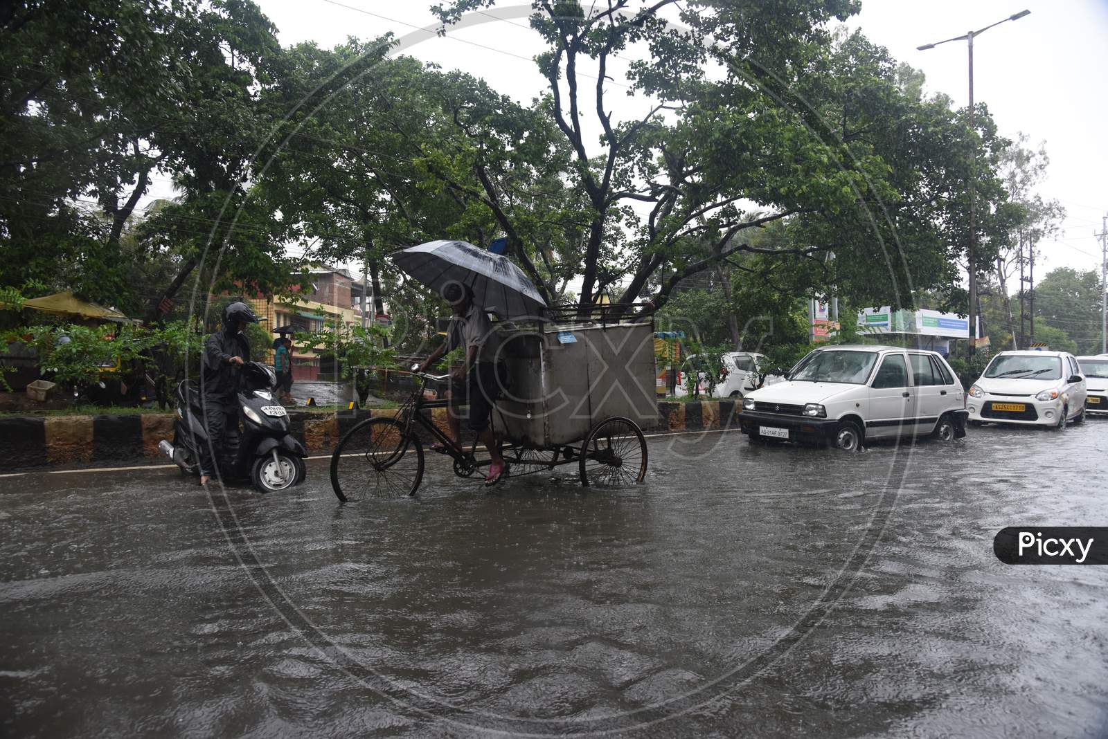 Commuting Vehicles Taking Risky  Rides On  Flooded Roads in Assam Due To Seasonal Floods in Guwahati City , Assam On June 13  2017