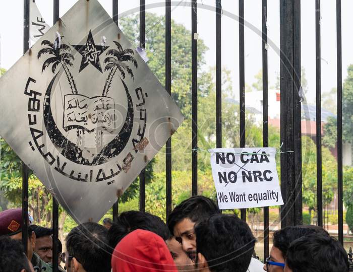 Logo of Jamia Millia Islamia University at the gate and anti CAA and anti NRC slogan put by protesting students