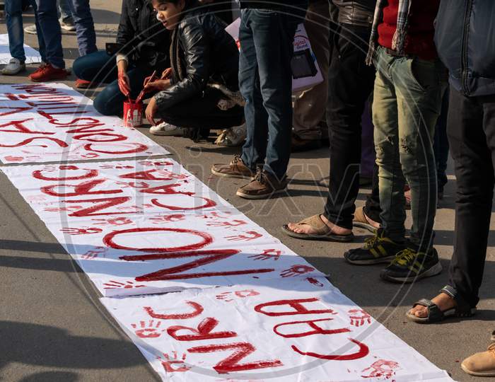 Students writing slogans for protest against CAA and NRC outside Jamia Millia Islamia, A Central University in New Delhi