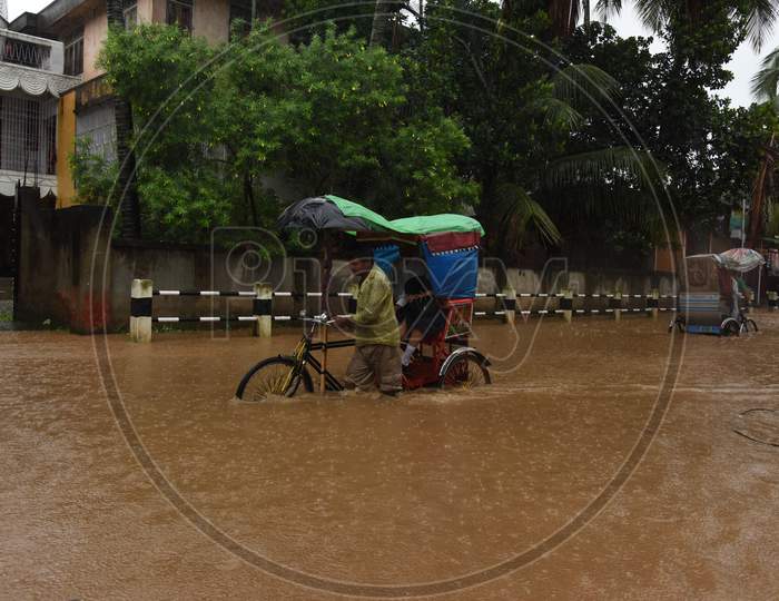 A Rickshaw Puller On The Flooded Roads Of Guwhati During Seasonal Floods in Guwahati City , Assam June 13 2017