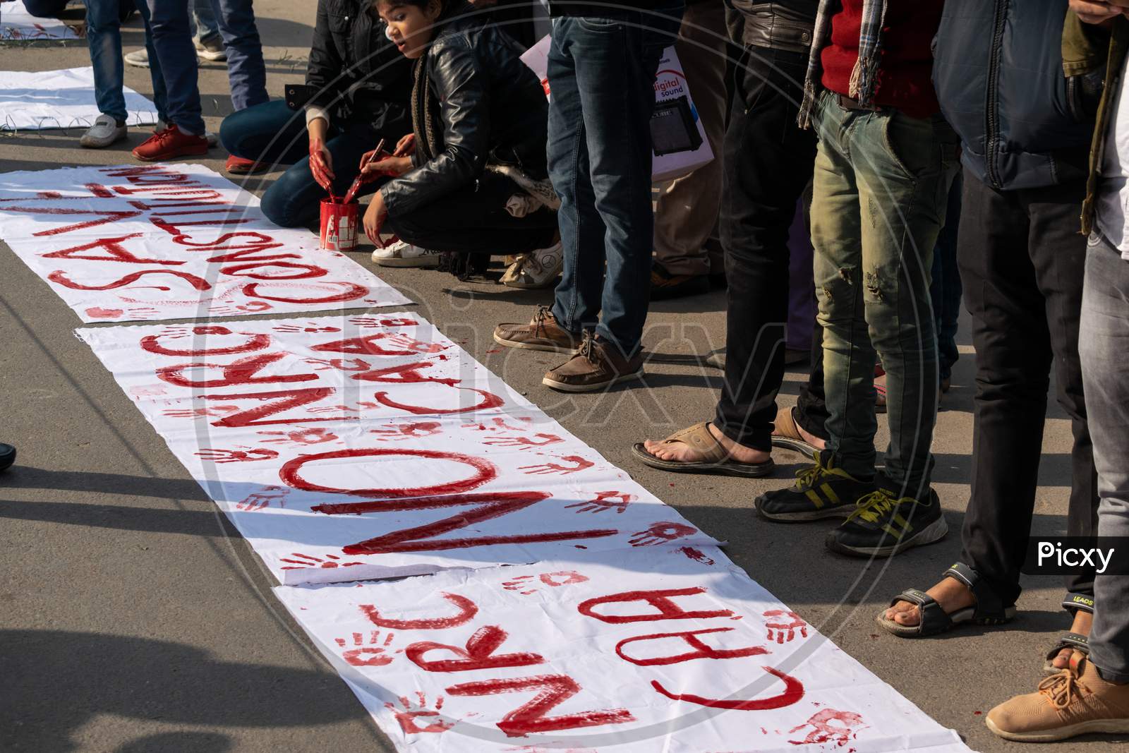 Students writing slogans for protest against CAA and NRC outside Jamia Millia Islamia, A Central University in New Delhi