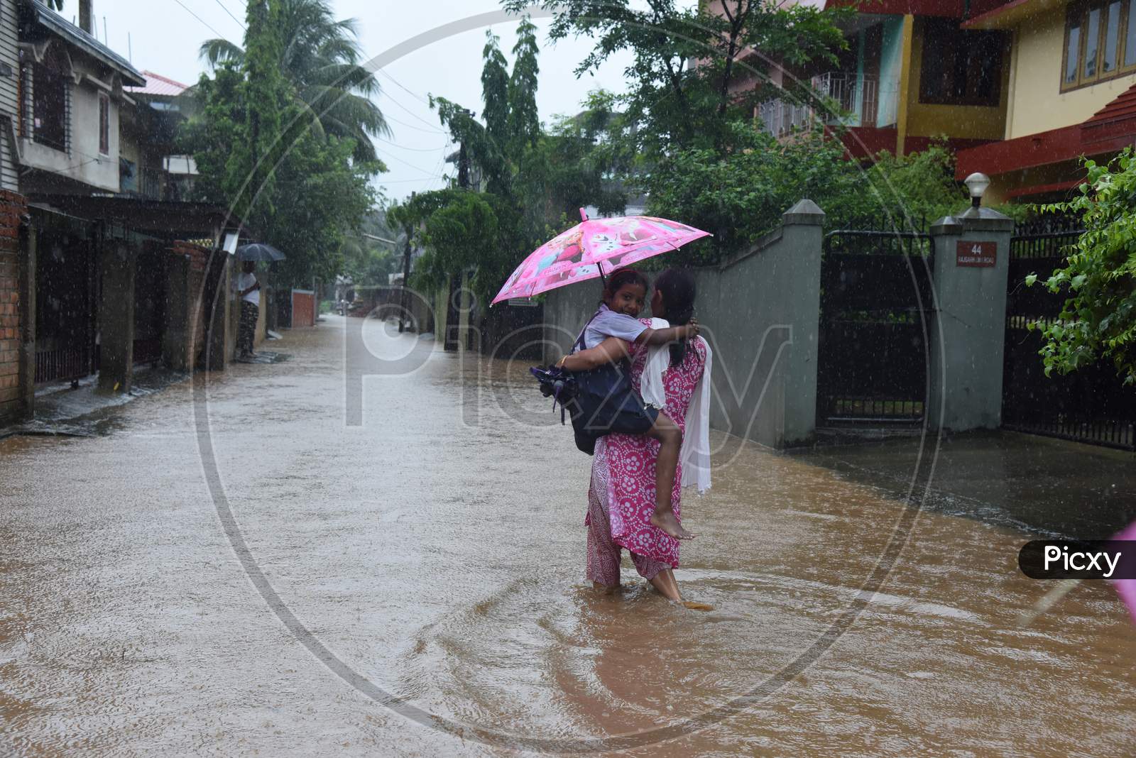 Pedestrians Taking Cover From Heavy Rain  Due To Seasonal Floods In Guwahati City, Assam On June 13 2017