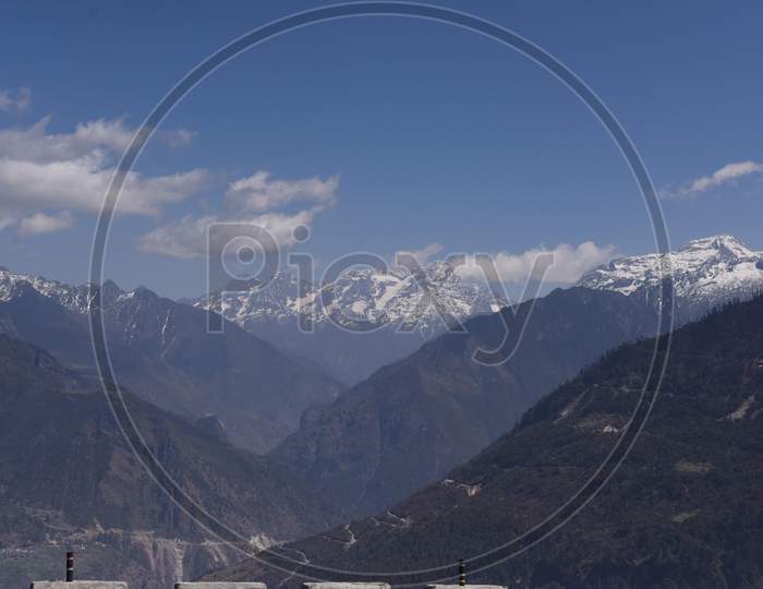 A Landscape n of Snow Filled Mountain Ranges With Valleys In  Arunachal Pradesh