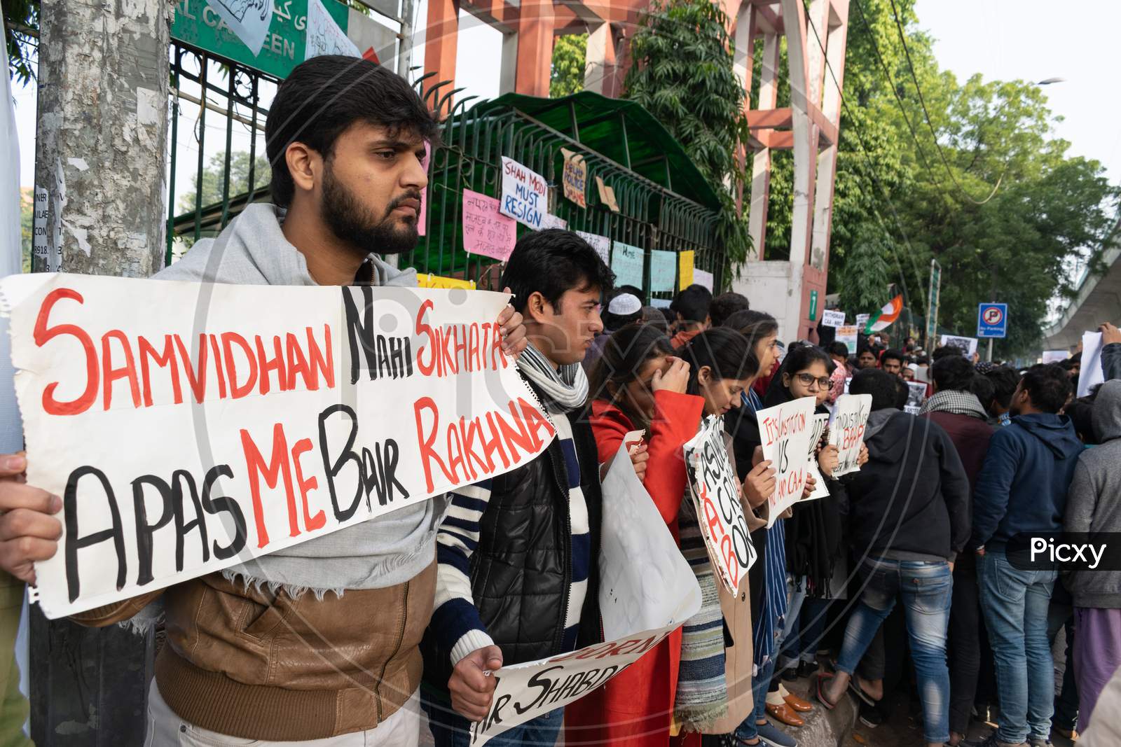 Students with slogans protesting against CAA and NRC outside Jamia Millia Islamia, A Central University in New Delhi