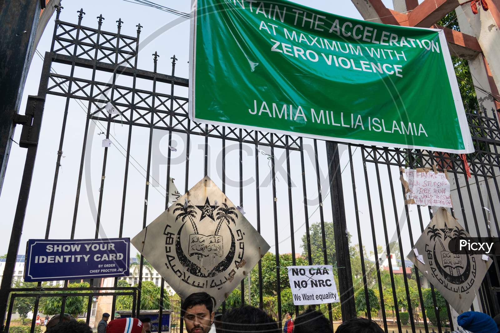 Logo of Jamia Millia Islamia University at the gate and anti CAA and anti NRC slogan put by protesting students