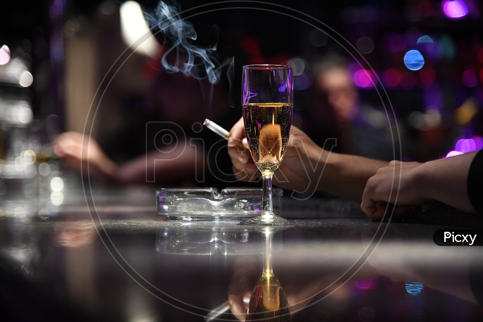 A Wine Glass With a Man Smoking Cigarette Hand Closeup
