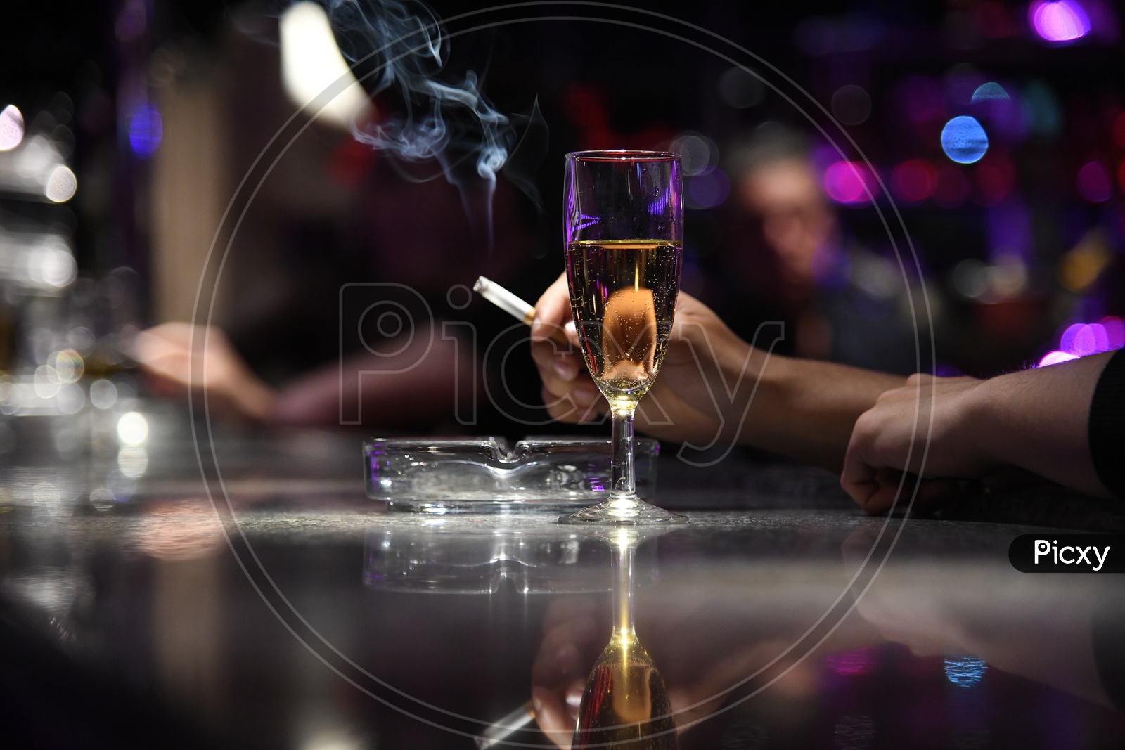 A Wine Glass With a Man Smoking Cigarette Hand Closeup