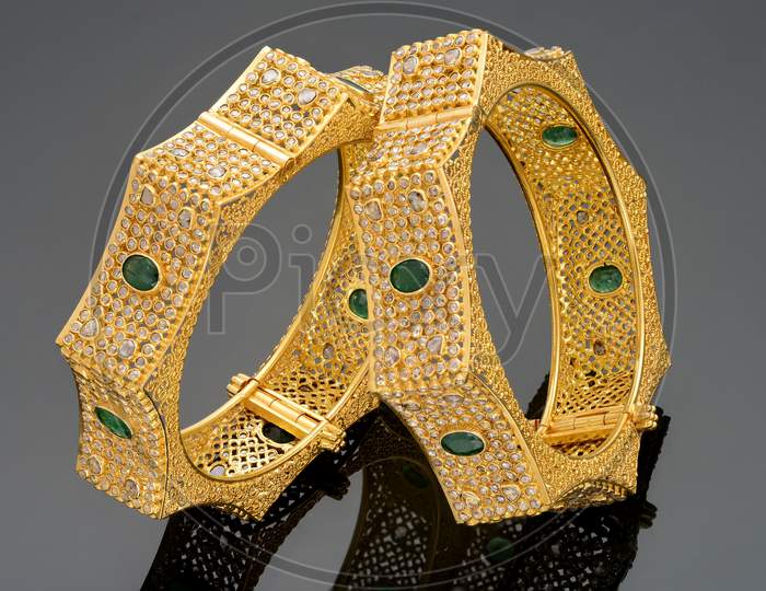 Greem gemstone embedded Gold Bangles