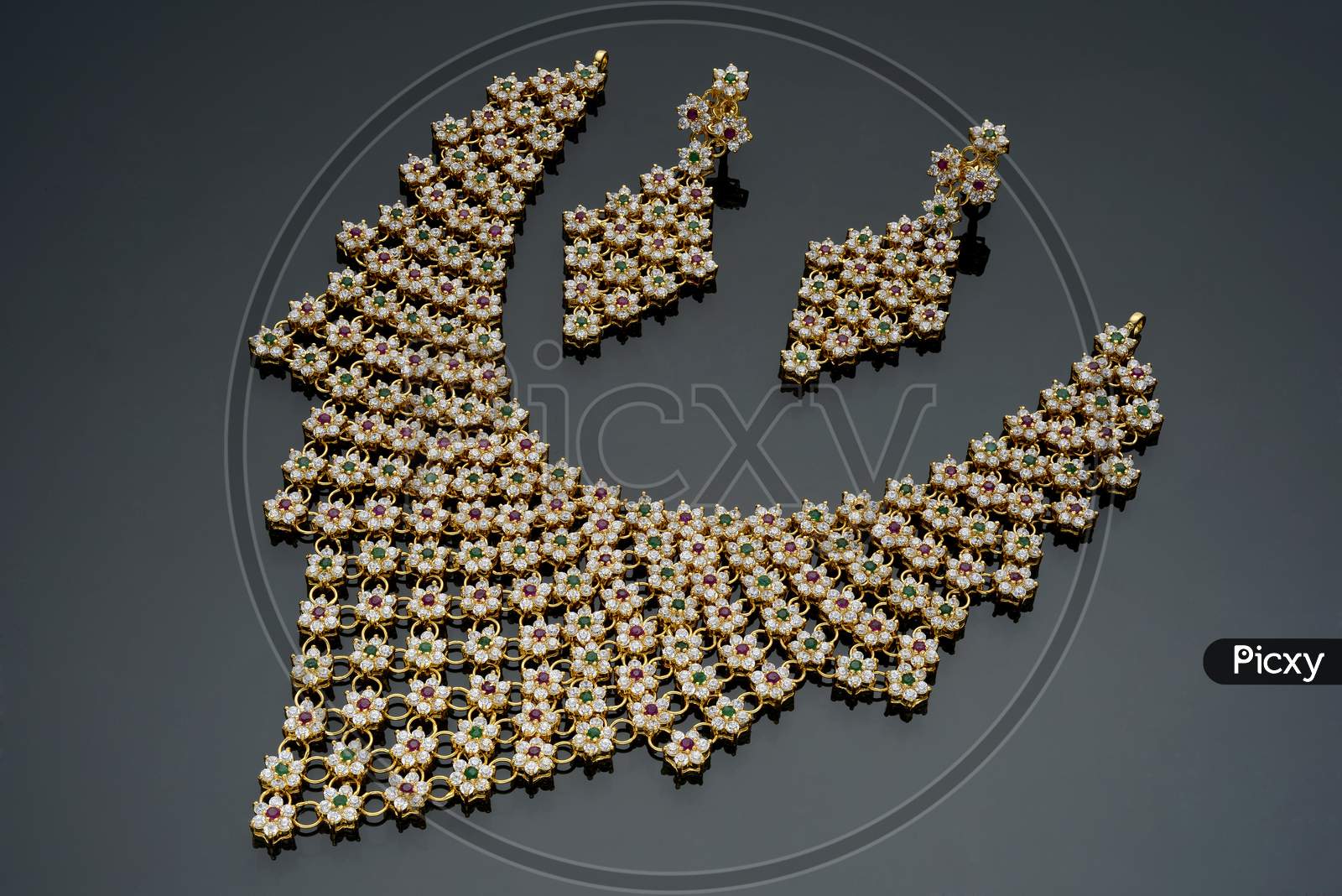 Indian Fancy small gemstone embedded necklace piece on a black background