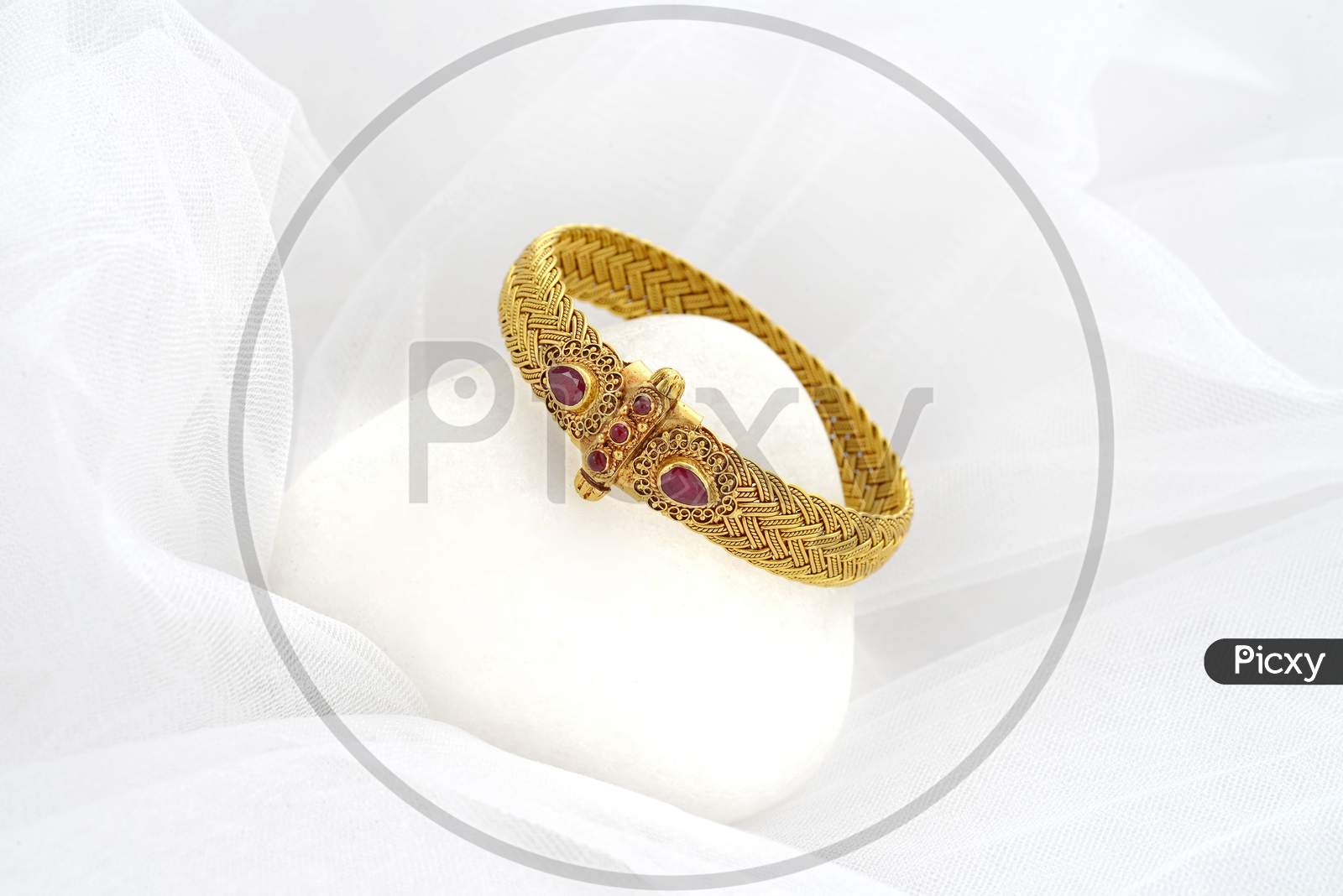 Close up of gold coated ring with gemstone