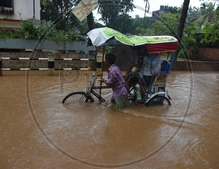A Rickshaw Riding   on Flooded Roads Of Guwahati Due To Seasonal Floods in Guwahati City , Assam