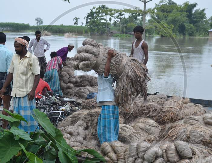 Assamese Farmers Transporting Jute  on Boats in Nagoan, Assam