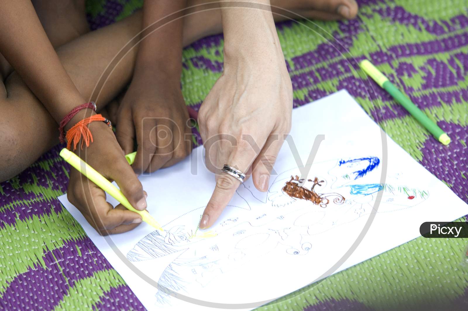 Indian village students drawing on a paper