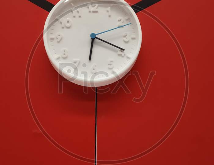 Wall Clock Over a Red Wall