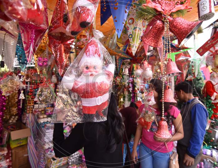 Young Woman Shopping Christmas Decoration Articles From Shops in Market in Guwahati, Assam