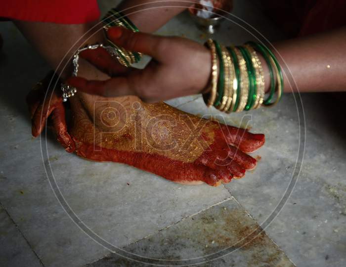 Indian Woman holding bride's anklet