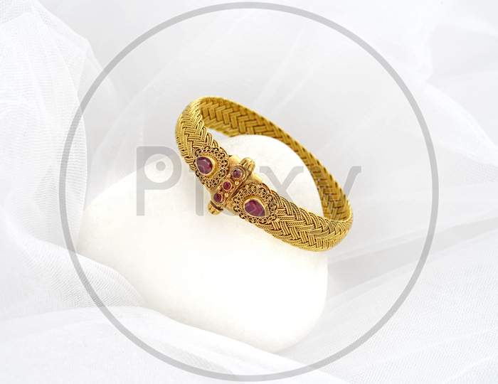 Close up of gold coated ring with gemstone
