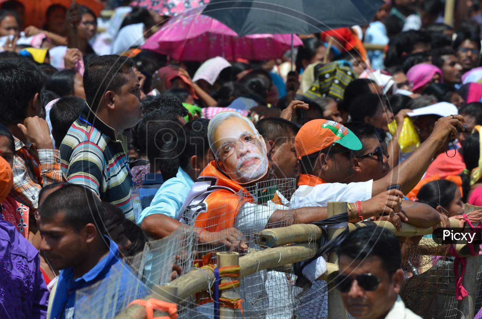 Bharatiya Janata Party (Bjp) Supporters Wearing The Mask Of Prime Minister  Narendra Modi  As He Participate  An Election Rally   In Support Of Bjp Candidate At Raha In Nagaon District Of Assam