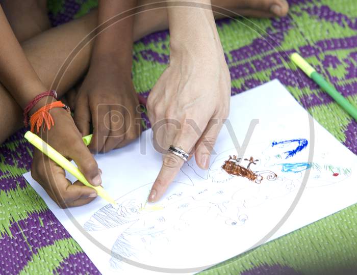 Indian village students drawing on a paper