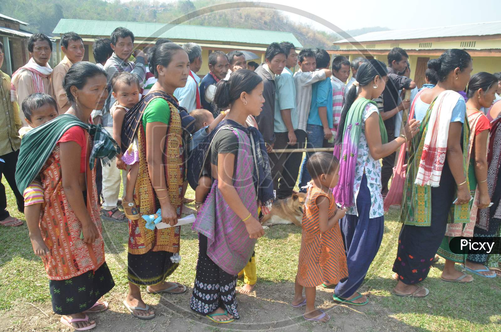 Indian Voters  Standing In Queue Lines For Casting Their Votes At Polling Booths During  Assam Assembly General Elections 2016