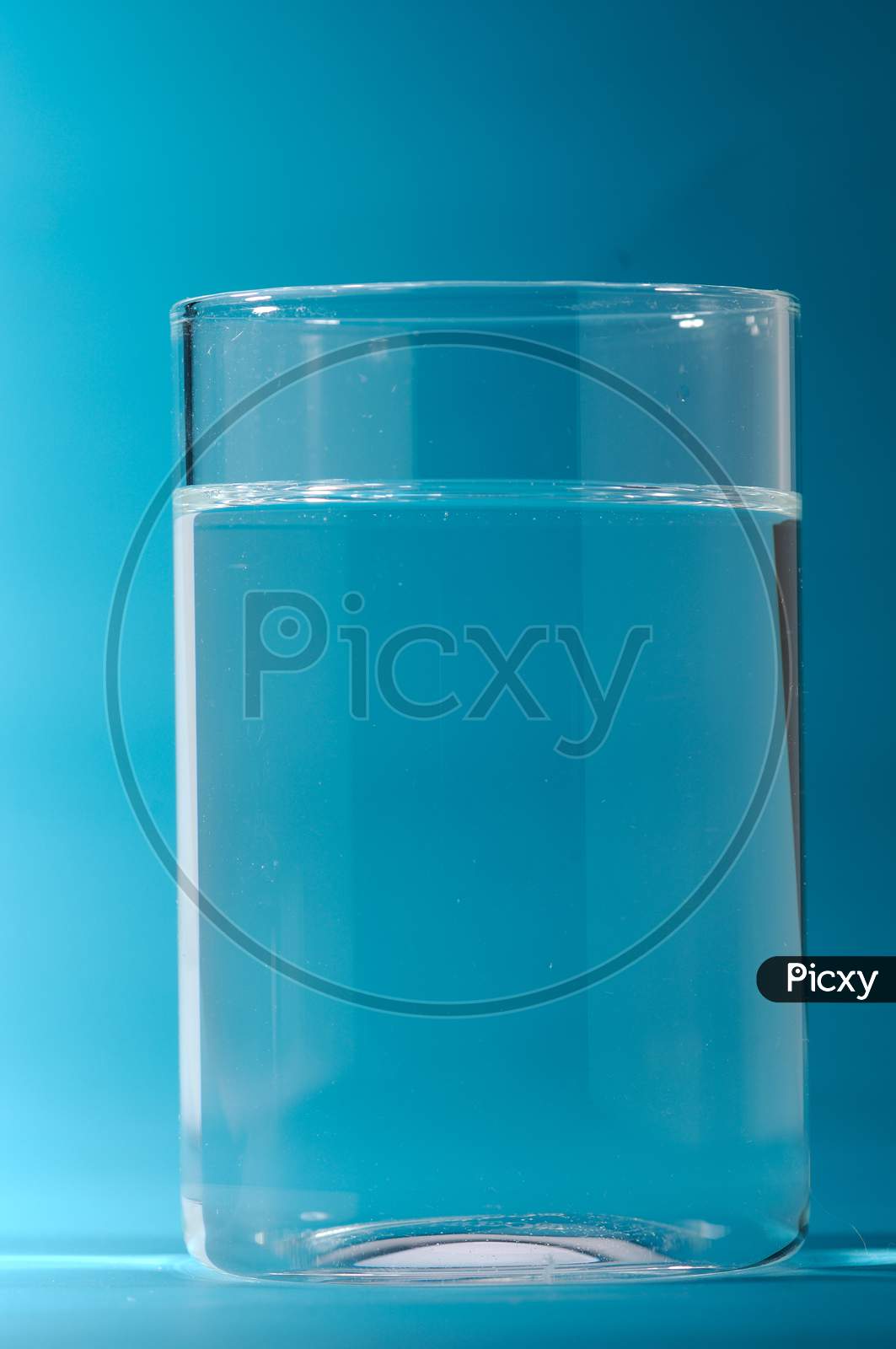 Glass Of Water With Blue Background