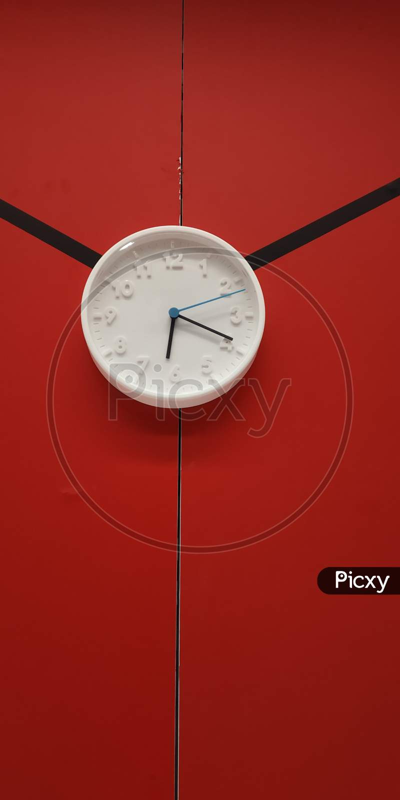 Wall Clock Over a Red Wall