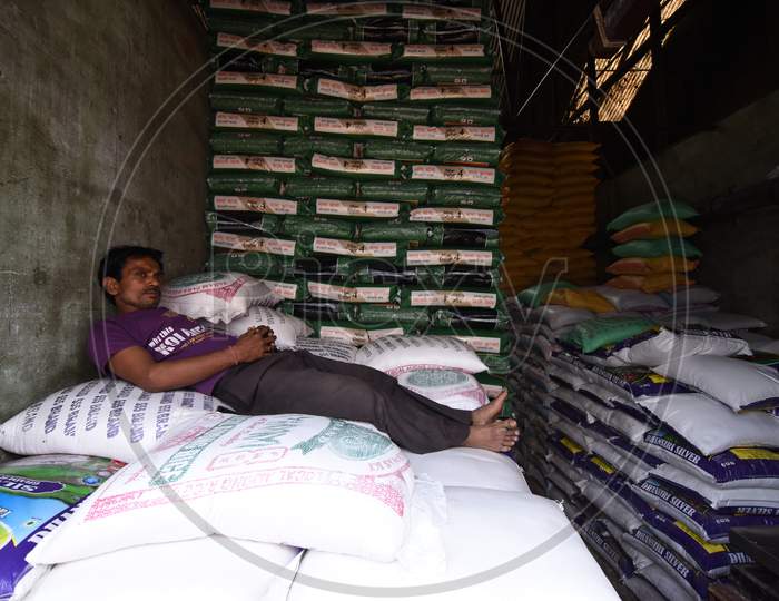 A Daily Worker Taking Rest On Rice Bags in an  Warehouse