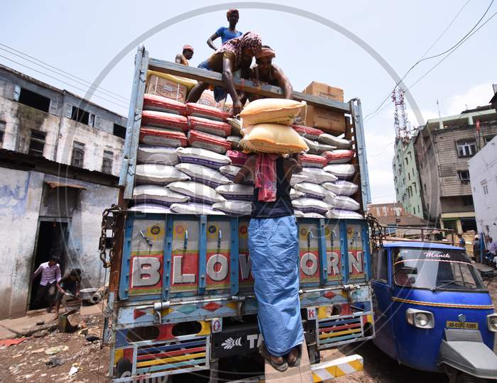 Daily Labor Worker Loading to Truck  With Goods Bags In an Market Warehouse