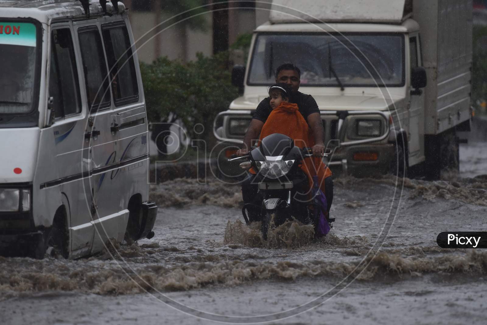 Commuting Vehicles Taking  Risky Rides on Flooded Roads Of Guwahati Due To Seasonal Floods in Guwahati City , Assam