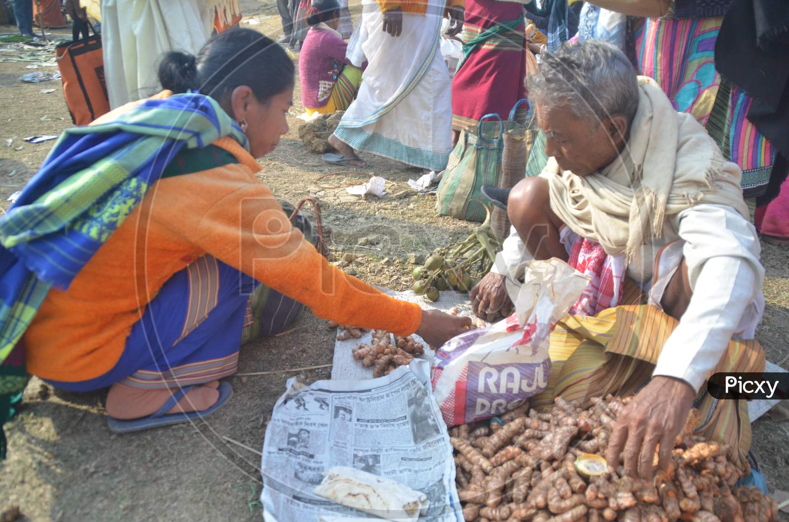 Assamese Woman  Purchasing Fresh Vegetables And Spices From Local Village Market in Morigaon , Assam