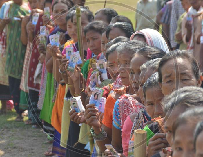 Indian Woman Showing Voter ID Cards by Standing In Queue Lines For Casting Vote in Assam Assembly Elections 2016