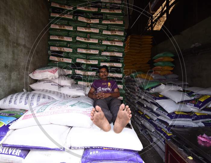 A Daily Worker Taking Rest On Rice Bags in an  Warehouse