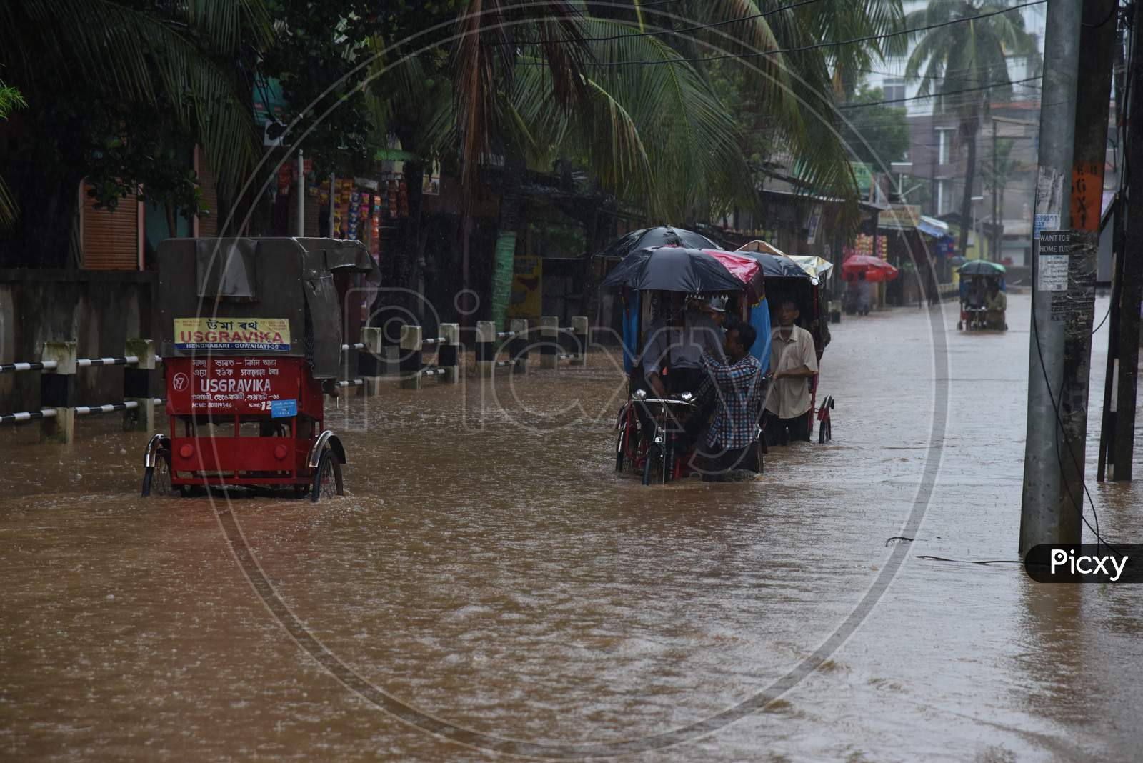 A Rickshaw Pullers  on Flooded Roads Of Guwahati Due To Seasonal Floods in Guwahati City , Assam