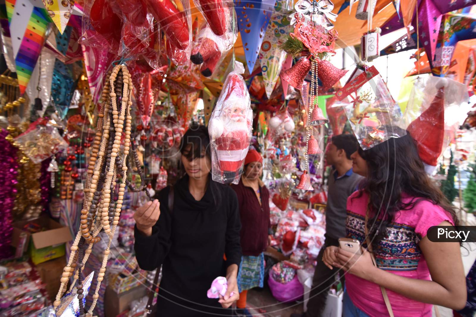 Young Woman Shopping Christmas Decoration Articles From Shops in Market in Guwahati, Assam