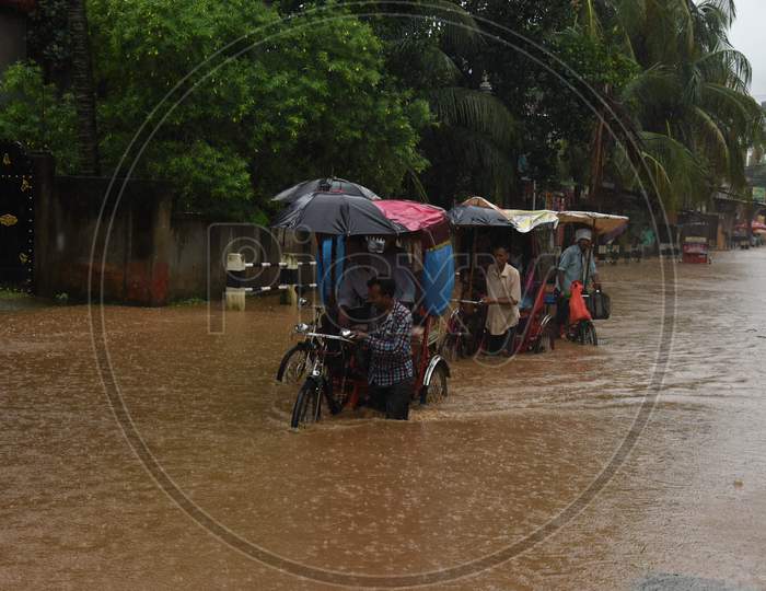 A Rickshaw Pullers  on Flooded Roads Of Guwahati Due To Seasonal Floods in Guwahati City , Assam