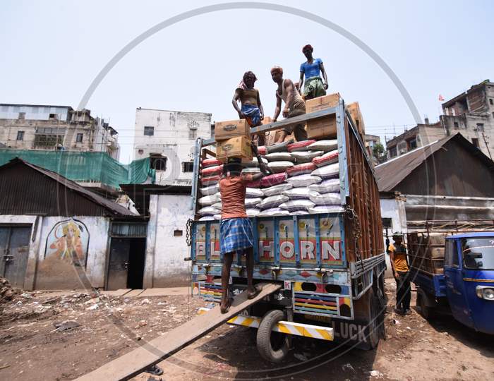 Daily Labor Worker Loading to Truck  With Goods Bags In an Market Warehouse