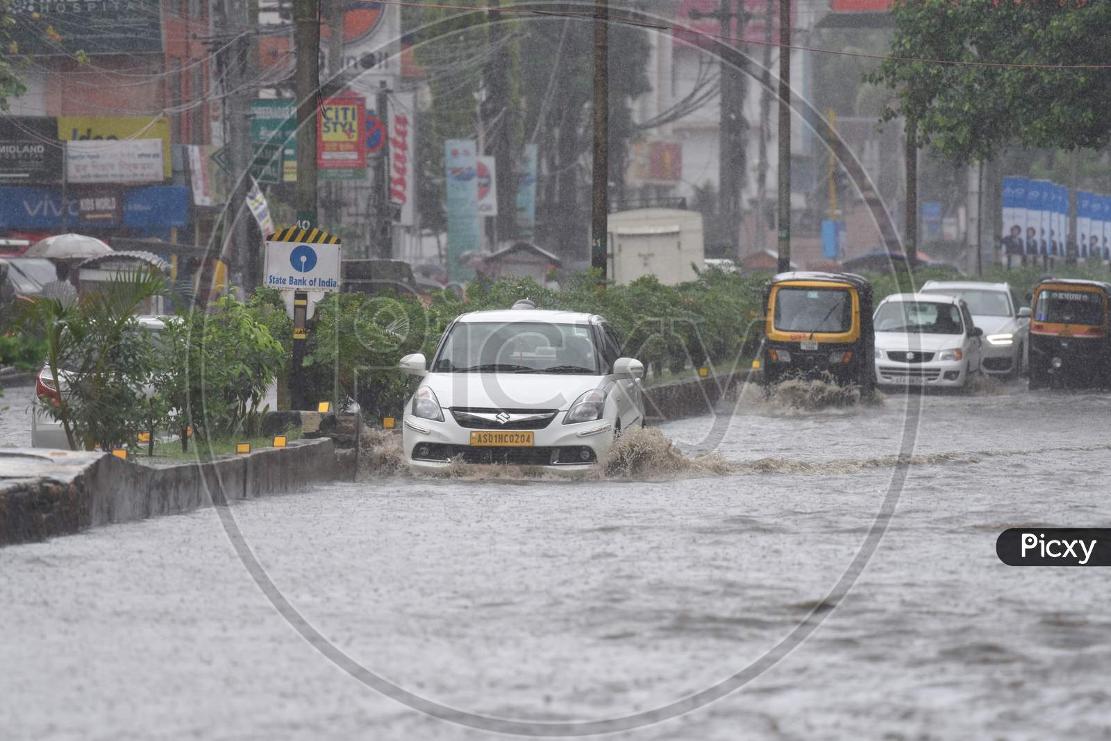 Commuting Vehicles Taking  Risky Rides on Flooded Roads Of Guwahati Due To Seasonal Floods in Guwahati City , Assam