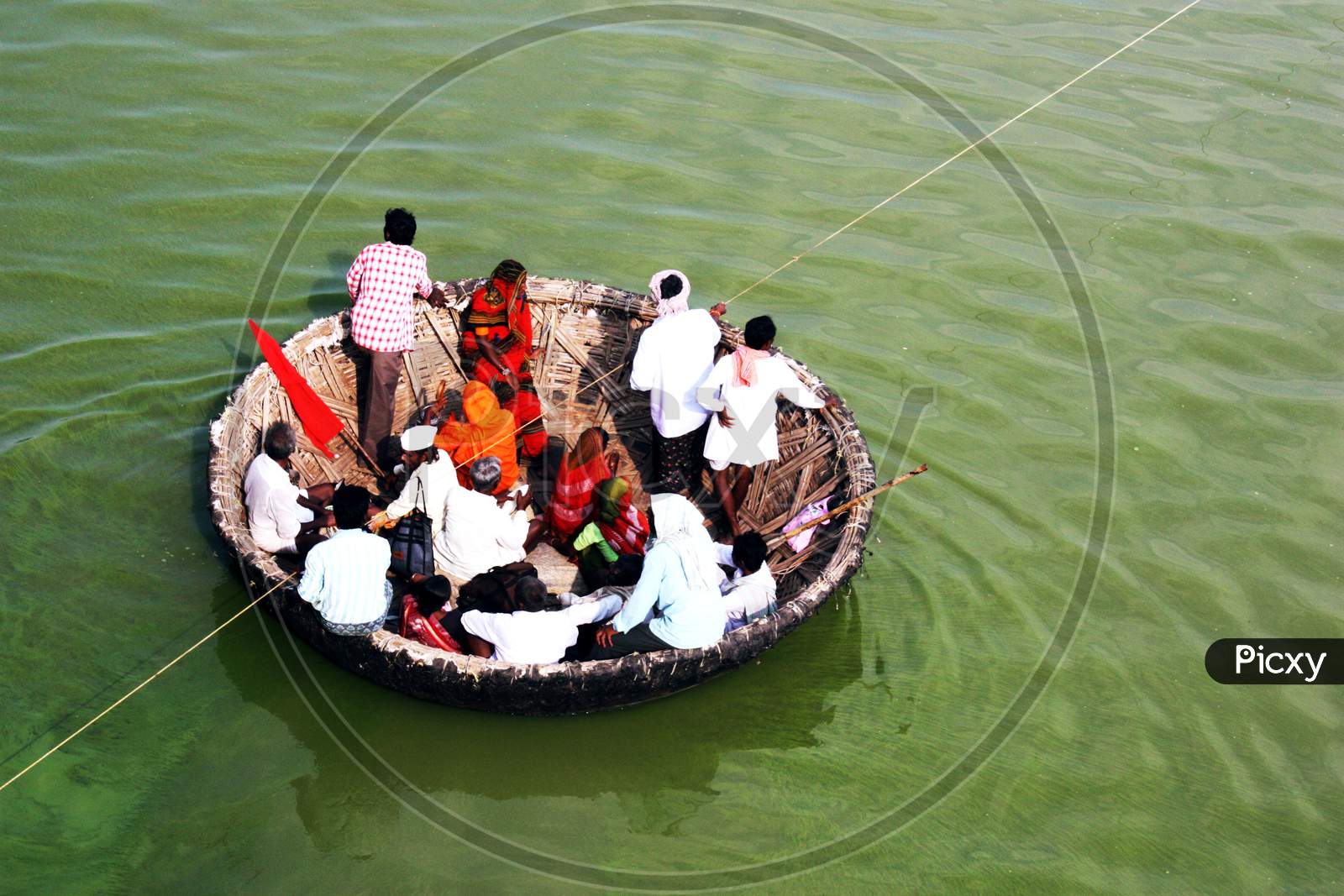 Villagers traveling in the wicker boat to cross the river