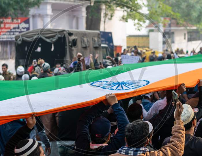people holding the indian flag Protesting Against Caa And Nrc