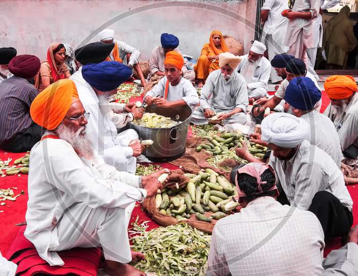 Cutting vegetables for the Langar at Golden Temple