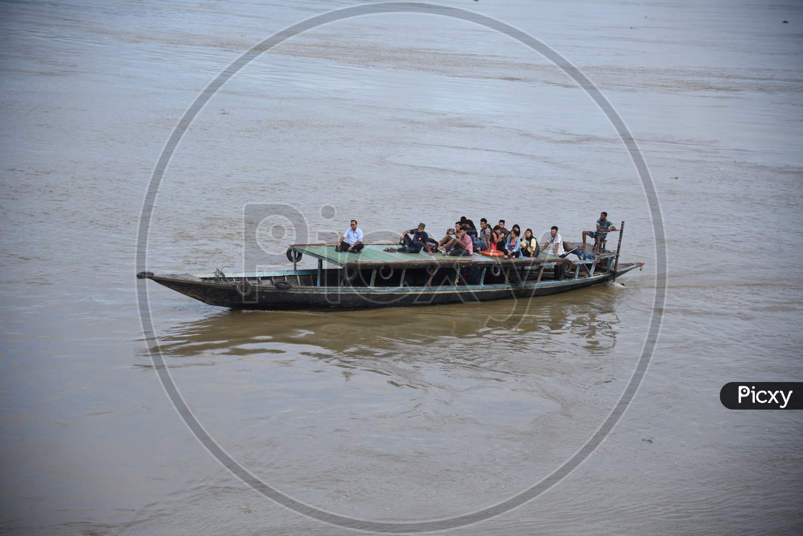 People from India's northeastern states travel on a boat through the waters of river Brahmaputra, back to their homes at Nimati Ghat, August 21, 2012