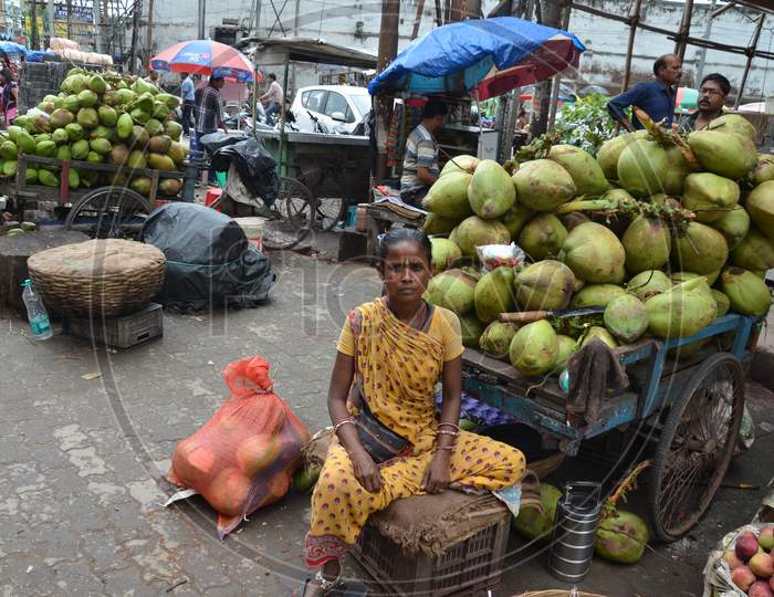 An Old Woman Selling Coconuts in Guwahati, Assam