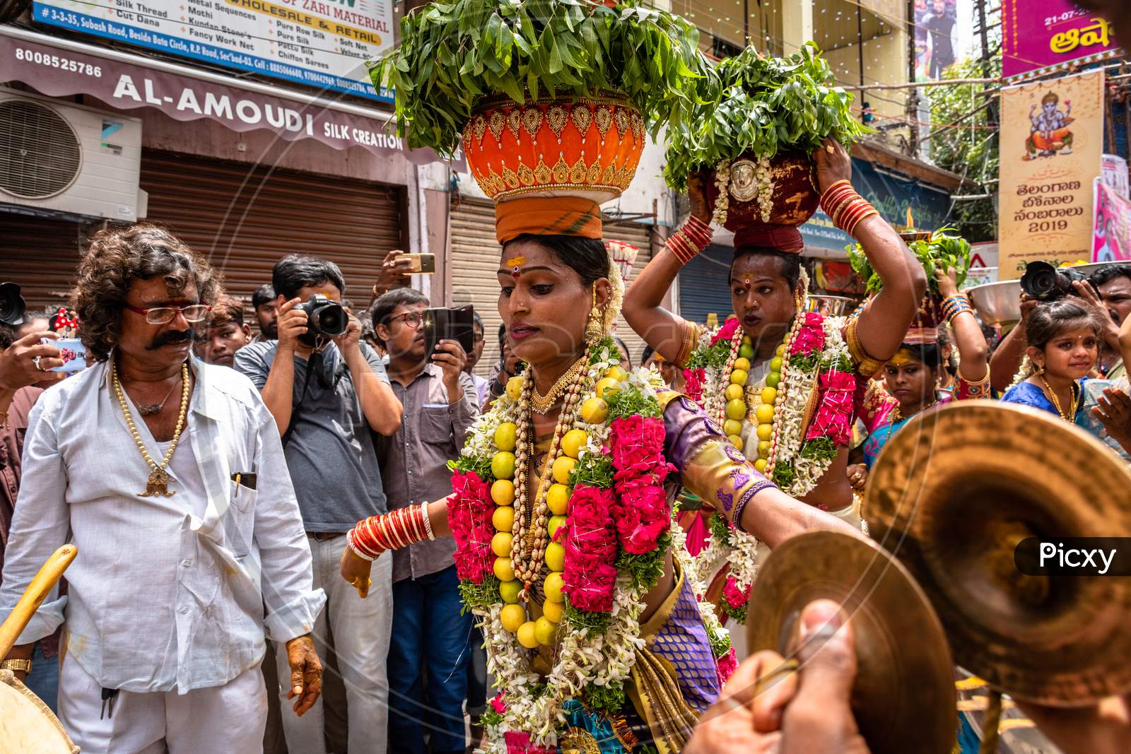 Bonalu Celebrations With Devotees Carrying Bonalu And Dancing