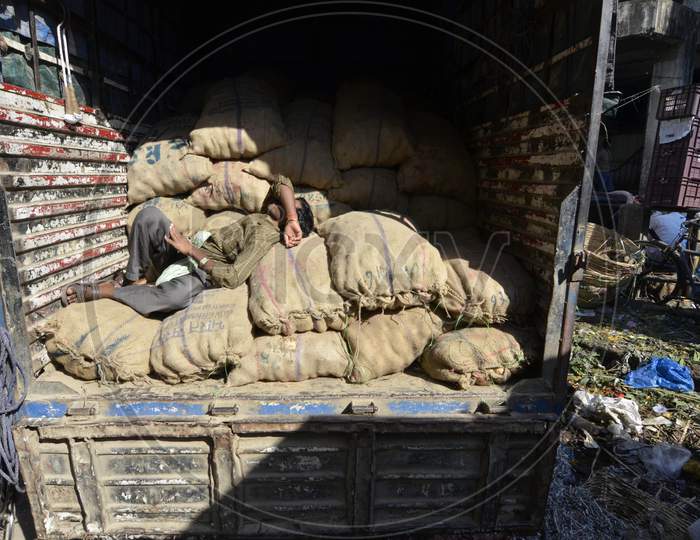 Daily Labor Worker Resting on Goods Bags  on a Transport Vehicle In Guwahati Fancy Bazaar , Assam