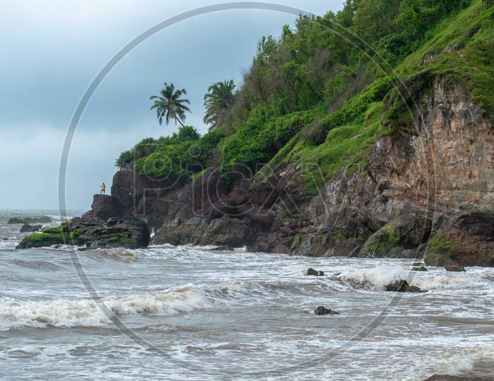 Rock Beach In Goa With Sea Waves Striking The Rocks