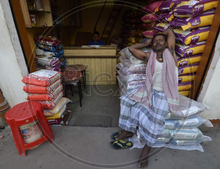 Vendors At Guwahati Bazaar Or Fancy Market  in Shops  With Goods Bags